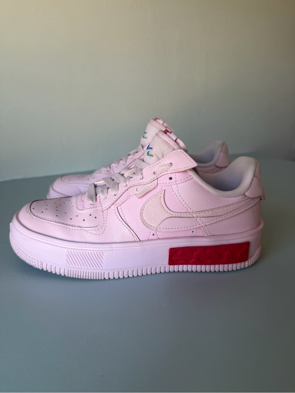 Nike Air Force 1 Women’s Light Pink Low-Top Sneakers with Red Accent